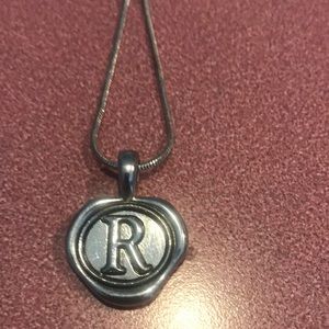 Silver toned snake chain necklace with an R pendant